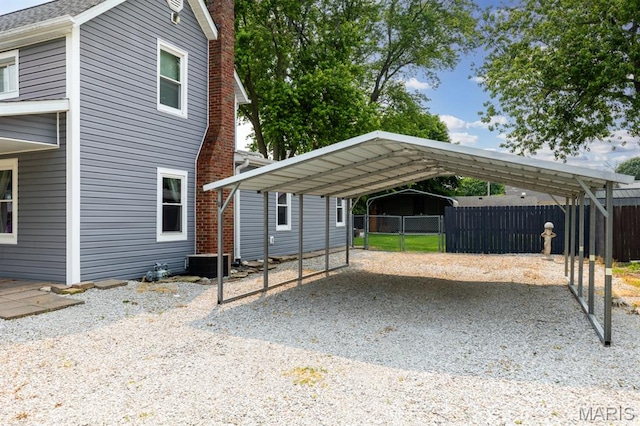 311 S Edwardsville St, Staunton, IL 62088 - view of property exterior with a detached carport, gravel driveway, and a chimney