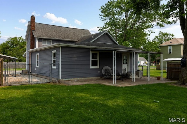 311 S Edwardsville St, Staunton, IL 62088 - back of property featuring a patio, a chimney, a gate, and roof with shingles