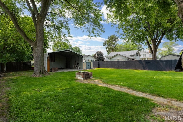 311 S Edwardsville St, Staunton, IL 62088 - fenced backyard featuring a storage unit and a detached carport