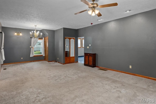 311 S Edwardsville St, Staunton, IL 62088 - empty room featuring a chandelier, carpet floors, ceiling fan, and a textured ceiling