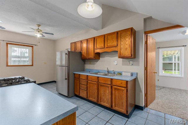 311 S Edwardsville St, Staunton, IL 62088 - kitchen featuring freestanding refrigerator, brown cabinets, a ceiling fan, and light countertops