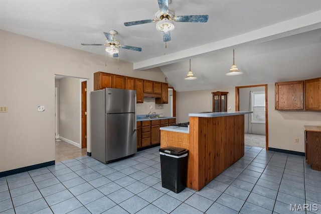 311 S Edwardsville St, Staunton, IL 62088 - kitchen featuring freestanding refrigerator, ceiling fan, brown cabinetry, and light countertops