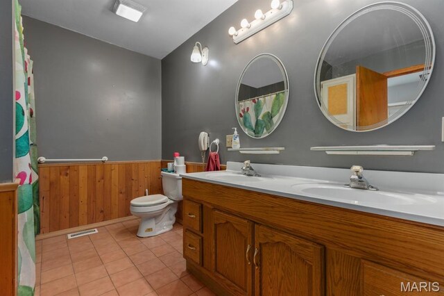 311 S Edwardsville St, Staunton, IL 62088 - bathroom with double vanity, a wainscoted wall, wooden walls, tile patterned flooring, and curtained shower