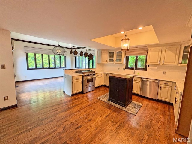 512 Overlook Terrace Ct, Eureka, MO 63025 - kitchen with appliances with stainless steel finishes, a peninsula, glass insert cabinets, a kitchen island, and light countertops