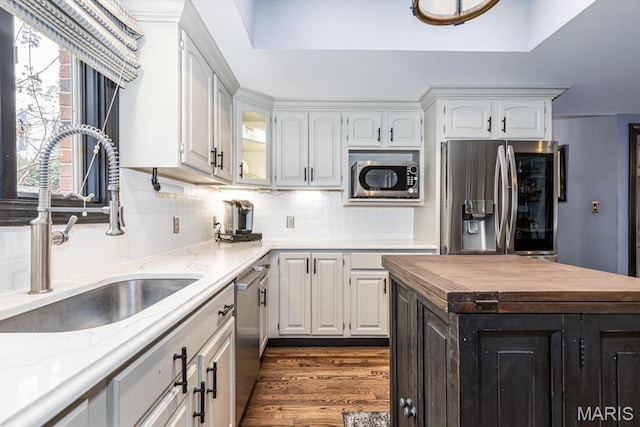 512 Overlook Terrace Ct, Eureka, MO 63025 - kitchen with stainless steel appliances, butcher block countertops, tasteful backsplash, white cabinetry, and dark wood finished floors