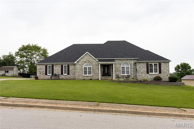 103 Woodland Ln, Saint Robert, MO 65584 - view of front of house with a front yard, brick siding, and a shingled roof