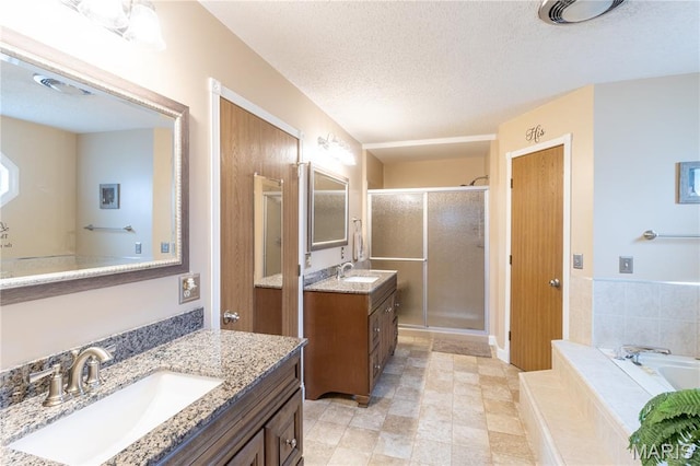 103 Woodland Ln, Saint Robert, MO 65584 - bathroom featuring a stall shower, two vanities, a bath, and a textured ceiling