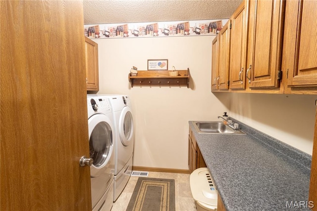 103 Woodland Ln, Saint Robert, MO 65584 - laundry area with independent washer and dryer, cabinet space, light tile patterned floors, and a textured ceiling