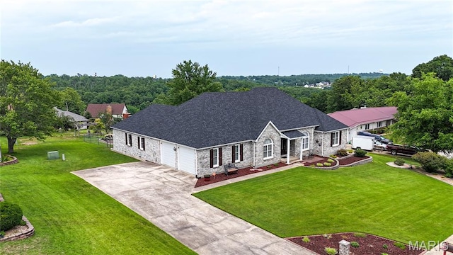 103 Woodland Ln, Saint Robert, MO 65584 - view of front of home with stone siding, a front lawn, a garage, and driveway