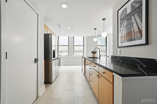 314 N Broadway Unit 806, Saint Louis, MO 63102 - kitchen with appliances with stainless steel finishes, a sink, dark countertops, light tile patterned floors, and recessed lighting