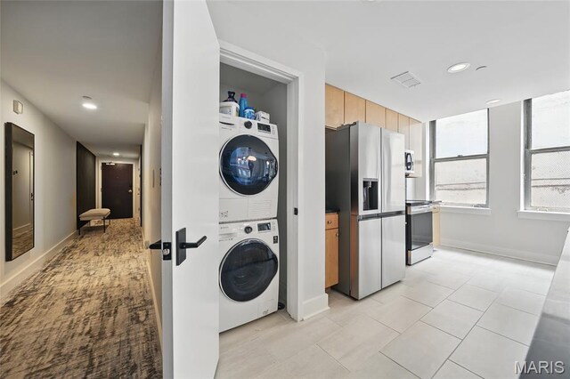 314 N Broadway Unit 806, Saint Louis, MO 63102 - washroom with stacked washer / dryer, baseboards, recessed lighting, and light tile patterned floors