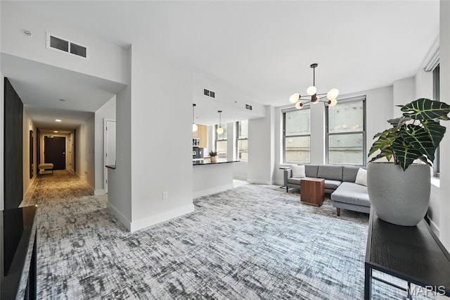 314 N Broadway Unit 806, Saint Louis, MO 63102 - carpeted living room featuring a chandelier and baseboards