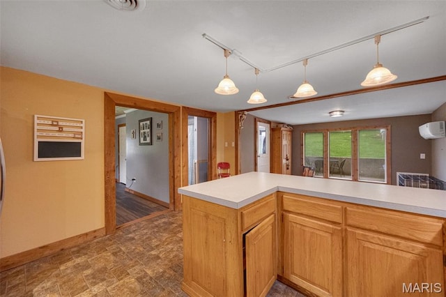 19185 Highway Hwy, Arcadia, MO 63621 - kitchen with an AC wall unit, light countertops, baseboards, and hanging light fixtures