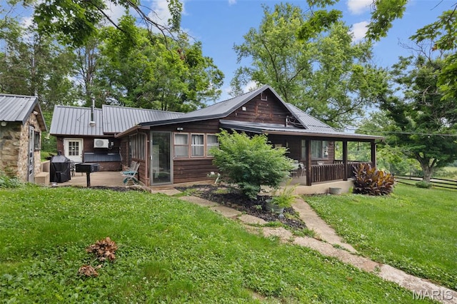 19185 Highway Hwy, Arcadia, MO 63621 - rear view of house with a sunroom, a patio, metal roof, a lawn, and an outbuilding