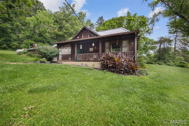 19185 Highway Hwy, Arcadia, MO 63621 - view of front of property with a porch, a front lawn, and metal roof