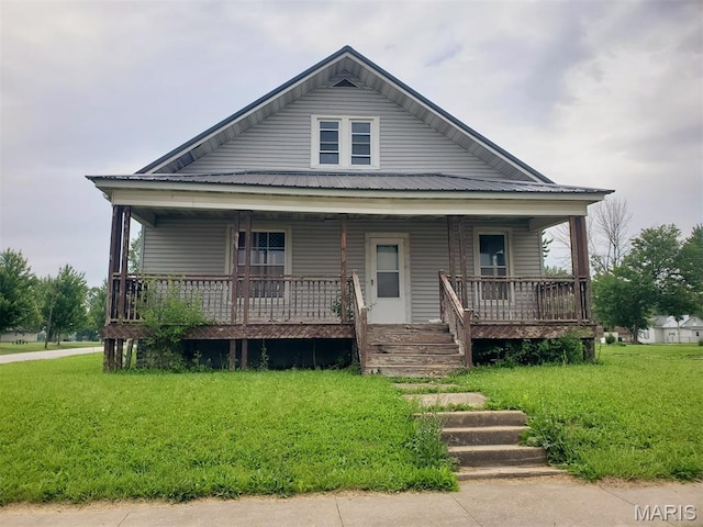 201 E Main St, Lewistown, MO 63452 - view of front of house with a porch, a front lawn, and metal roof