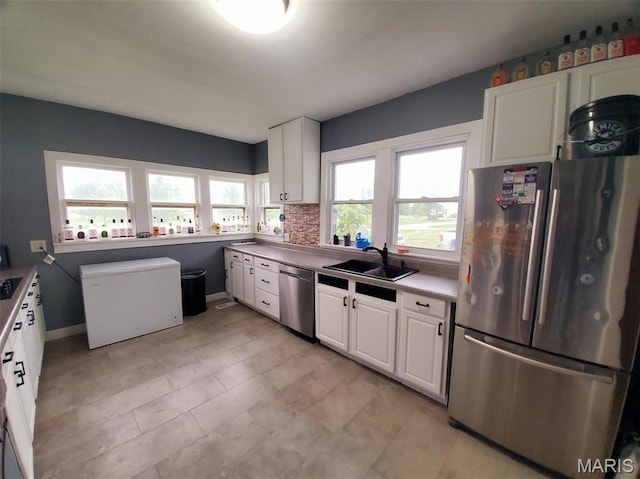 201 E Main St, Lewistown, MO 63452 - kitchen with appliances with stainless steel finishes, a sink, white cabinets, and baseboards