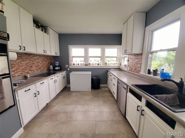 201 E Main St, Lewistown, MO 63452 - kitchen featuring dishwasher, a sink, tasteful backsplash, white cabinetry, and refrigerator