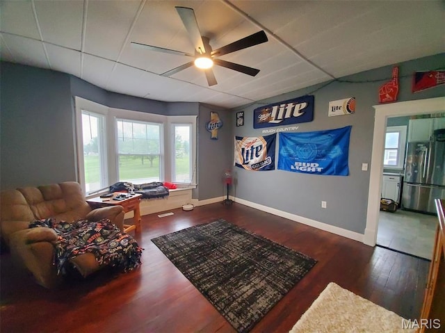 201 E Main St, Lewistown, MO 63452 - living area featuring ceiling fan, wood finished floors, baseboards, and a drop ceiling