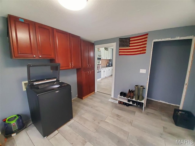 201 E Main St, Lewistown, MO 63452 - kitchen featuring light wood finished floors, dark brown cabinets, and fridge