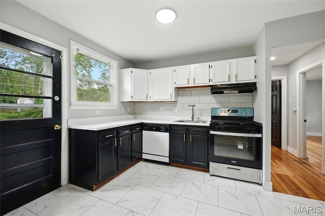1005 Edgehill Dr, Ferguson, MO 63135 - kitchen with stainless steel gas stove, dishwasher, under cabinet range hood, white cabinets, and light countertops
