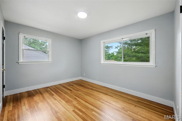 1005 Edgehill Dr, Ferguson, MO 63135 - spare room featuring healthy amount of natural light and light wood-type flooring