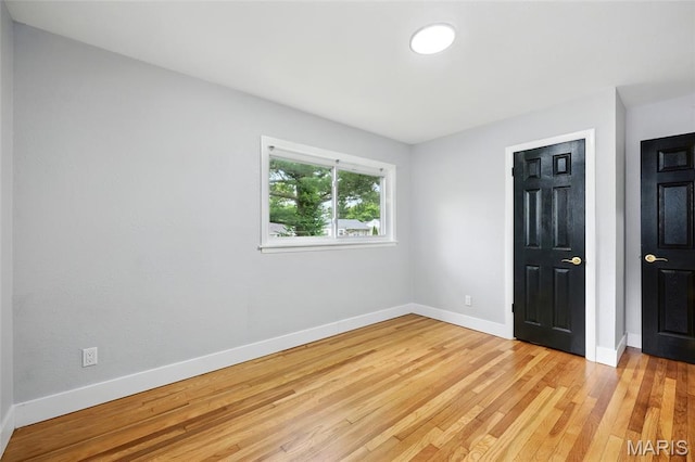 1005 Edgehill Dr, Ferguson, MO 63135 - unfurnished bedroom with light wood-style floors and baseboards