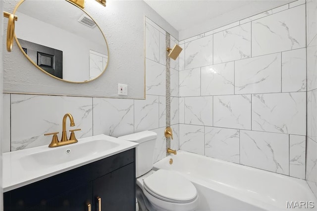 1005 Edgehill Dr, Ferguson, MO 63135 - full bathroom with vanity, bathtub / shower combination, tile walls, and backsplash