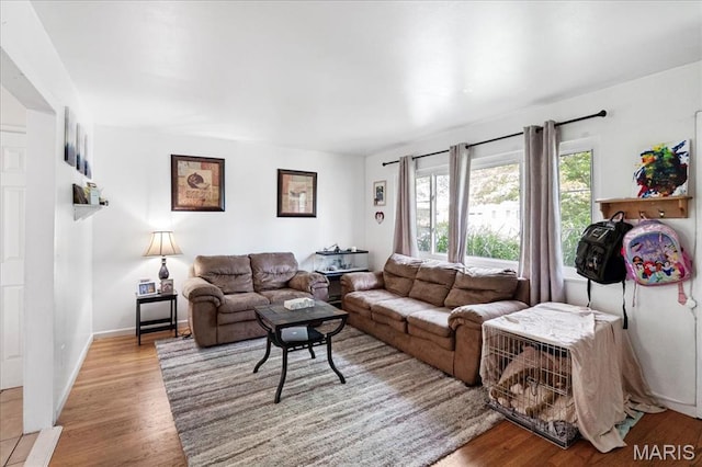 1910 Flamingo Dr, Florissant, MO 63031 - living room featuring wood finished floors and baseboards