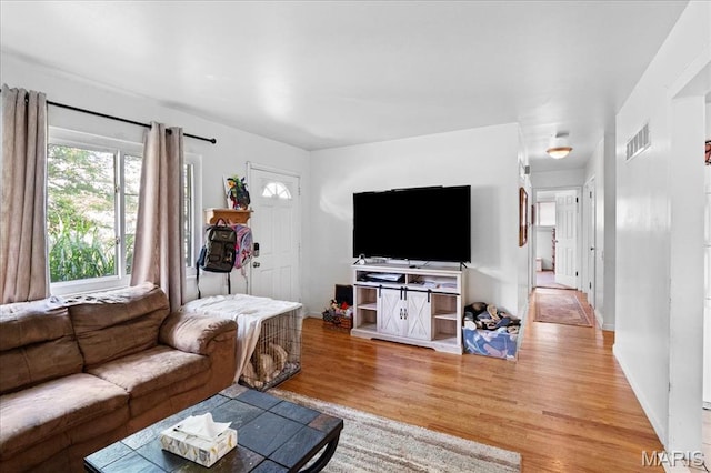 1910 Flamingo Dr, Florissant, MO 63031 - living room featuring healthy amount of natural light and wood finished floors