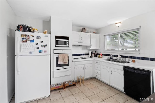 1910 Flamingo Dr, Florissant, MO 63031 - kitchen featuring white appliances, a warming drawer, white cabinets, light tile patterned flooring, and light countertops