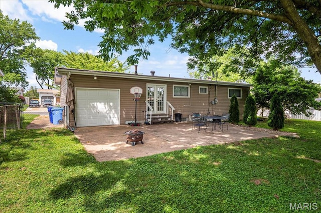 1910 Flamingo Dr, Florissant, MO 63031 - rear view of property with entry steps, a garage, an outdoor fire pit, a patio area, and french doors