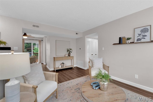 9179 N Swan Cir, Brentwood, MO 63144 - living room featuring wood finished floors, baseboards, a ceiling fan, and a textured ceiling