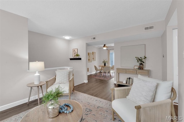 9179 N Swan Cir, Brentwood, MO 63144 - living area featuring wood finished floors, ceiling fan, a textured ceiling, and baseboards