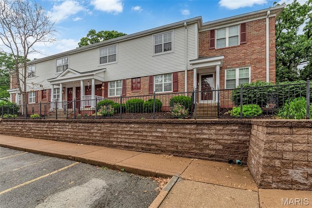 9179 N Swan Cir, Brentwood, MO 63144 - view of property with brick siding and uncovered parking