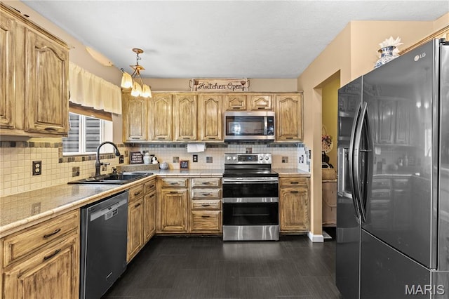 818 Sheraton Ln, Herculaneum, MO 63048 - kitchen with stainless steel appliances, a sink, light countertops, tasteful backsplash, and hanging light fixtures