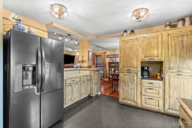 818 Sheraton Ln, Herculaneum, MO 63048 - kitchen with stainless steel fridge, a textured ceiling, rail lighting, light countertops, and a peninsula
