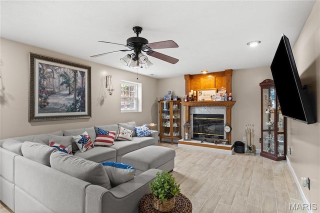 818 Sheraton Ln, Herculaneum, MO 63048 - living room featuring wood finished floors, ceiling fan, a premium fireplace, and baseboards