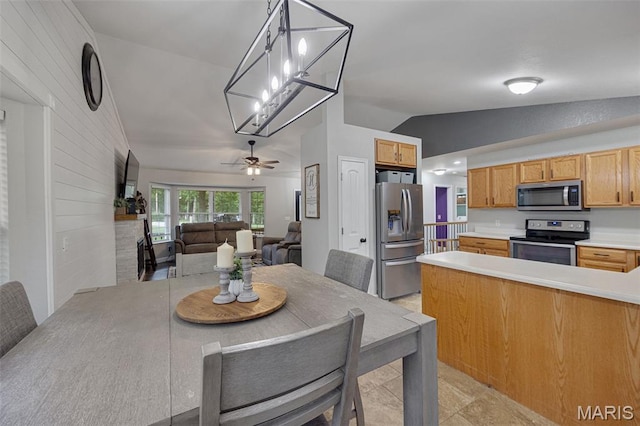 10041 Fox Haven Rd, Blackwell, MO 63626 - kitchen with appliances with stainless steel finishes, vaulted ceiling, open floor plan, light countertops, and wood walls