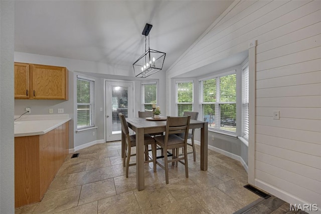 10041 Fox Haven Rd, Blackwell, MO 63626 - dining area with vaulted ceiling, light stone finish flooring, plenty of natural light, baseboards, and a chandelier