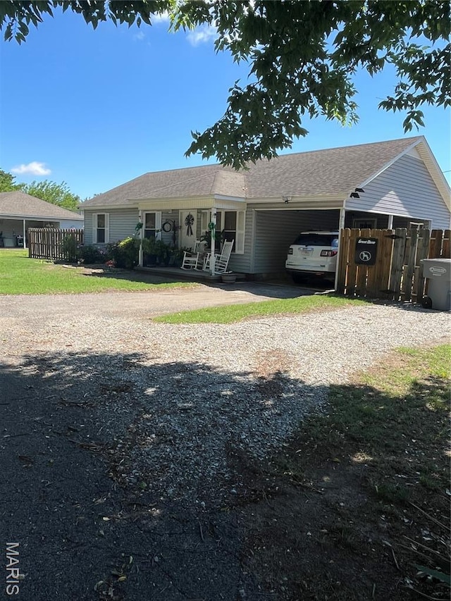 1600 Jennifer Ln, Kennett, MO 63857 - rear view of house featuring driveway and an attached carport
