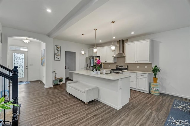 708 Kenmare Ct, Ofallon, MO 63368 - kitchen with wall chimney range hood, appliances with stainless steel finishes, a sink, dark wood finished floors, and baseboards