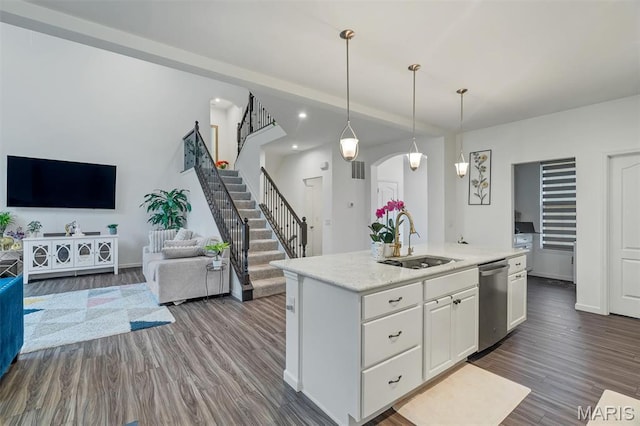 708 Kenmare Ct, Ofallon, MO 63368 - kitchen with stainless steel dishwasher, a sink, white cabinets, dark wood-type flooring, and arched walkways