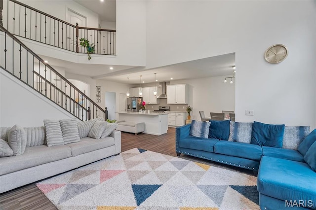 708 Kenmare Ct, Ofallon, MO 63368 - living room featuring a towering ceiling, wood finished floors, stairs, and recessed lighting