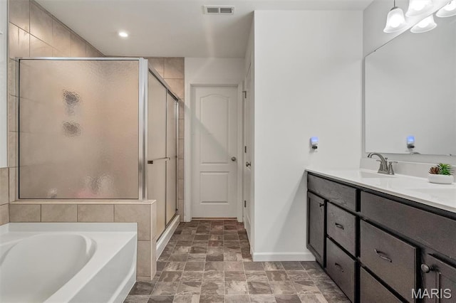 708 Kenmare Ct, Ofallon, MO 63368 - bathroom with vanity, a shower stall, a bath, baseboards, and stone finish floors