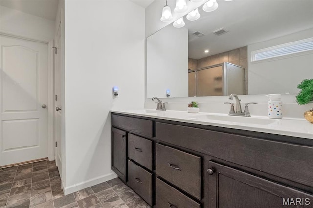 708 Kenmare Ct, Ofallon, MO 63368 - full bathroom featuring double vanity, a shower stall, baseboards, and stone finish floors
