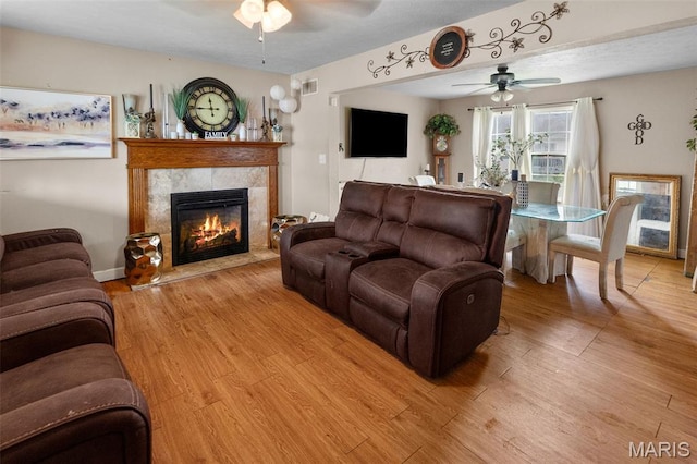 806 Erika Leigh Ct, Caseyville, IL 62232 - living area featuring a ceiling fan, light wood-style floors, and a tile fireplace
