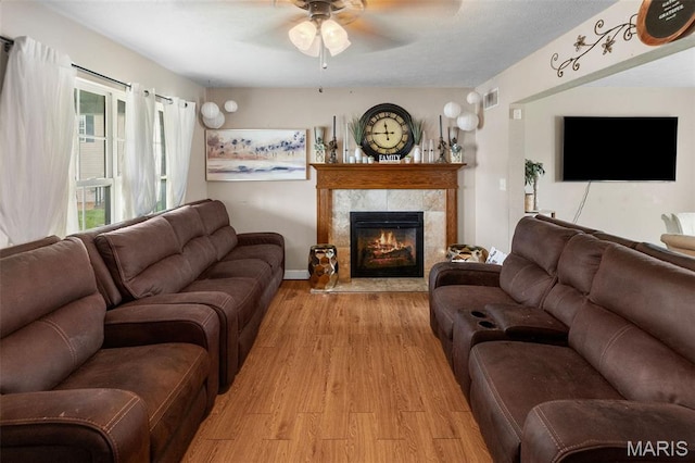 806 Erika Leigh Ct, Caseyville, IL 62232 - living room featuring light wood finished floors, a ceiling fan, and a tiled fireplace