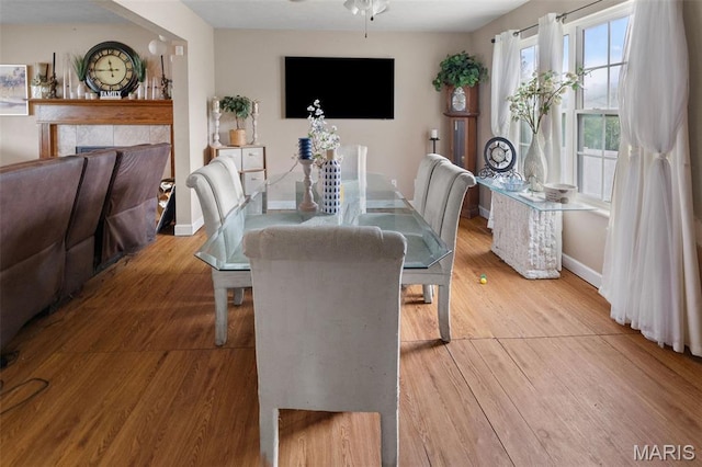 806 Erika Leigh Ct, Caseyville, IL 62232 - dining space featuring wood finished floors, a tile fireplace, and ceiling fan