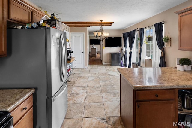 806 Erika Leigh Ct, Caseyville, IL 62232 - kitchen with freestanding refrigerator, brown cabinetry, a textured ceiling, range with electric stovetop, and pendant lighting